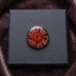 Red flower encased in resin accessory