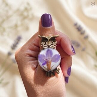 Elara Resin Ring shown on a hand to highlight the unique handmade floral ring