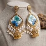Close-up of real blue daisy and Queen Anne's Lace in resin jhumka