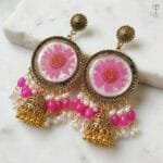 Close-up of real pink daisy flower with gold flecks in Gilded Daisy Jhumka