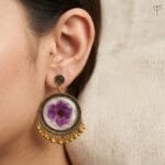 Model wearing Lilac Veil Resin Jhumka - real flower earrings with pearl tassels
