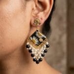 Model wearing the Onyx Daisy Jhumka, showing the diamond panel and cascading black and pearl fringe.