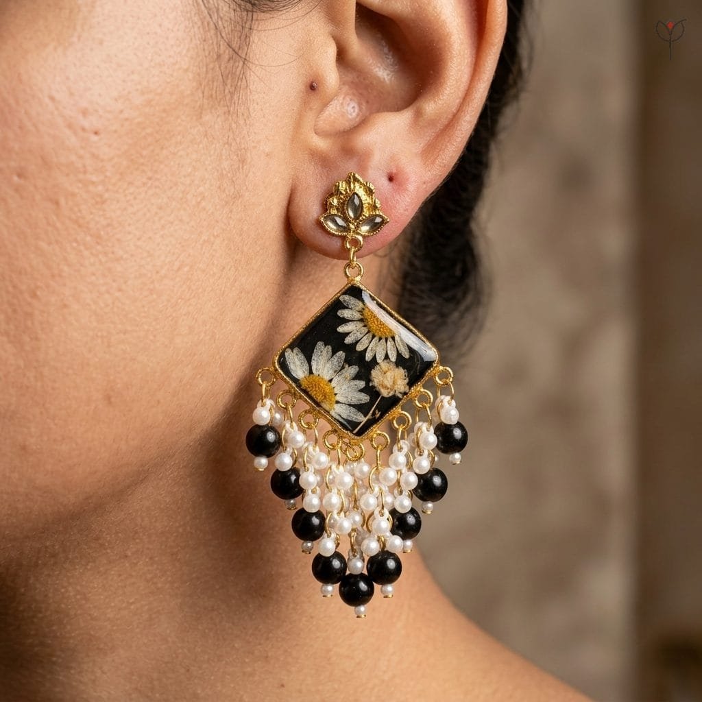 Model wearing the Onyx Daisy Jhumka, showing the diamond panel and cascading black and pearl fringe.