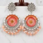 Close view of the pressed aster bloom sealed in coral resin at the centre of the Sundried Aster Resin Jhumka.