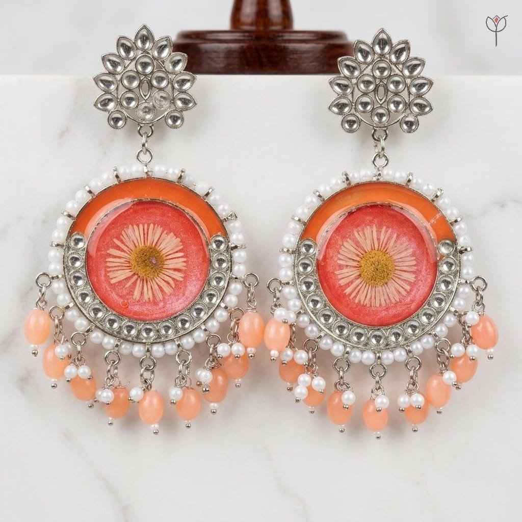 Close view of the pressed aster bloom sealed in coral resin at the centre of the Sundried Aster Resin Jhumka.