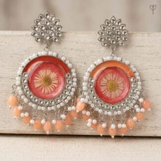 Sundried Aster Resin Jhumka with a pressed aster flower set in coral resin, framed in silver kundan with pearl beading.
