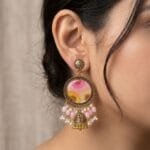 MystikFalls Honey Blush Jhumkas worn by model Antique gold pressed flower resin jhumka earrings showing pearl