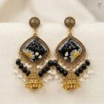 MystikFalls Midnight Garden Jhumkas Real pressed daisy and baby's breath in black resin with antique gold diamond-shaped frame