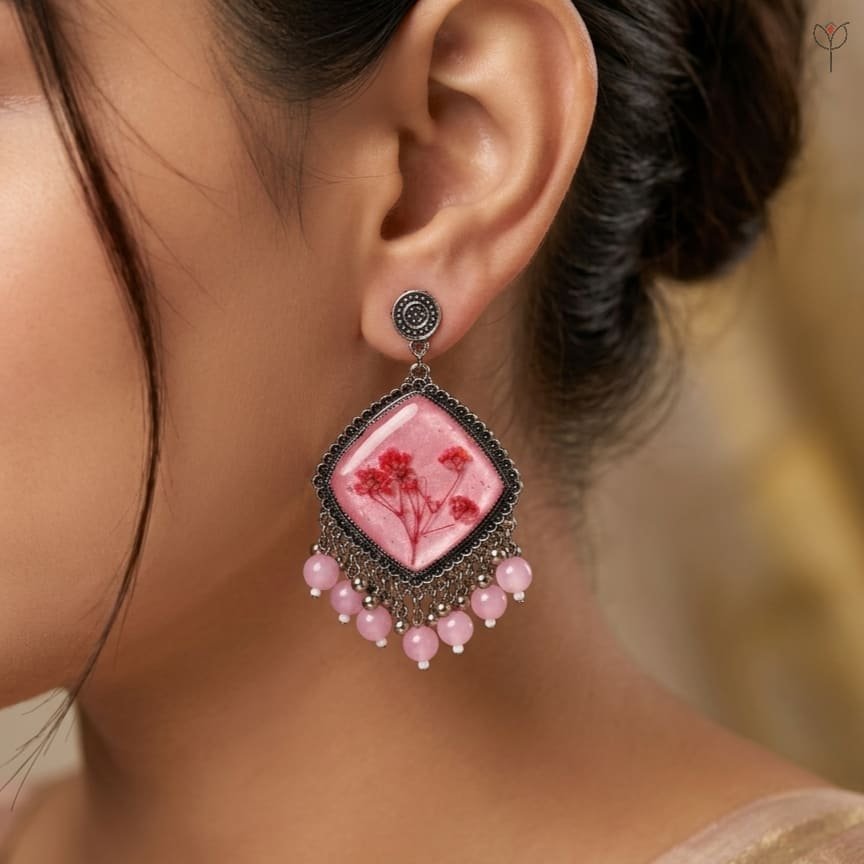 mystikfalls-pink-frost-jhumkas-on-model-side-profile MystikFalls Pink Frost Jhumkas worn by model Silver oxidised pressed flower resin jhumka earrings