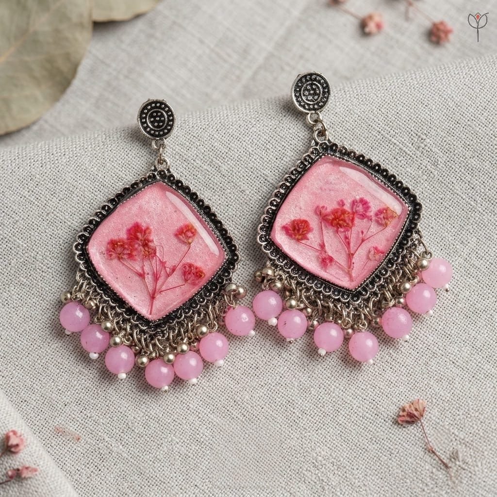 mystikfalls-pink-frost-jhumkas-pressed-babys-breath-pink-resin-earrings MystikFalls Pink Frost Jhumkas Real pressed baby's breath flowers in pink resin with silver oxidised diamond-shaped frame and pink bead dangles