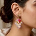 MystikFalls Rose Dew Jhumkas worn by model Golden pressed flower resin jhumka earrings showing pearl and pink bead cascade movement