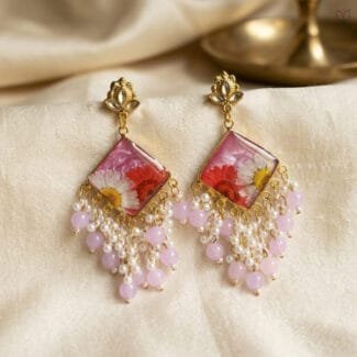 MystikFalls Rose Dew Jhumkas Real pressed daisy and red aster in pink resin with golden diamond-shaped frame