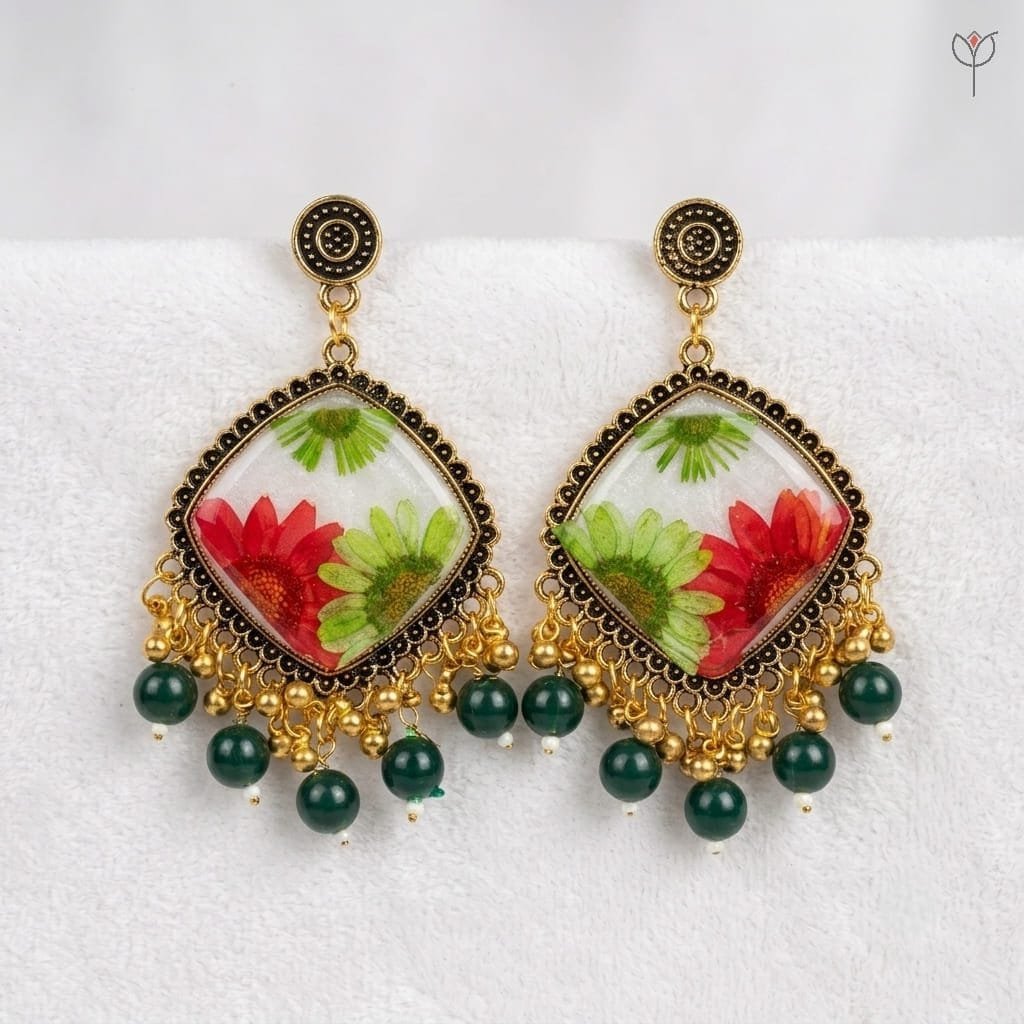mystikfalls-scarlet-garden-jhumkas-close-up-resin-flower-detail MystikFalls Scarlet Garden Jhumkas Real pressed red aster and green daisy in clear resin with antique gold diamond-shaped frame