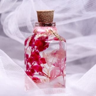 Alchemists Promise Glass Garden close-up of real preserved botanicals and dried flowers in clear mineral oil