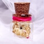 Candlelit Sunflower Preserved Glass Garden displayed as cozy warm toned floral decor beside a candle on a shelf