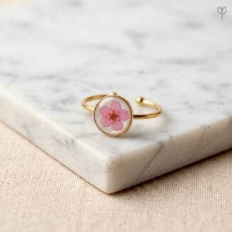 Cherry Spell Ring with dried pink plum flower set in clear resin round setting with golden open band by Mystik Falls