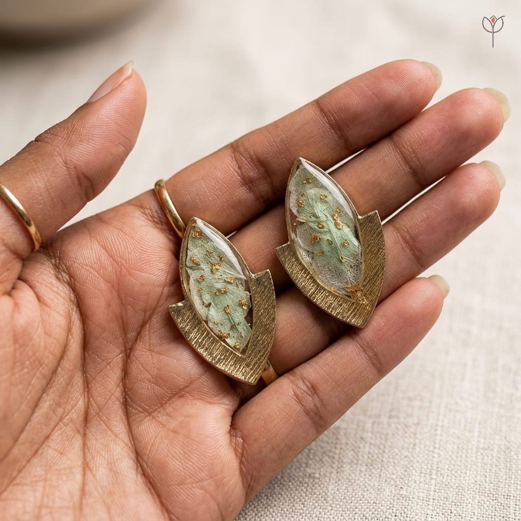 elara-resin-earrings-handcrafted-botanical-jewellery-india Elara Resin Earrings styled as handcrafted botanical jewellery with real hydrangea flowers preserved in resin set in gold-toned marquise studs