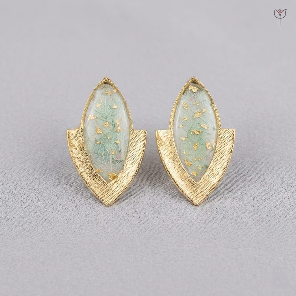 elara-resin-earrings-hydrangea-gold-marquise-studs-mystikfalls Elara Resin Earrings featuring preserved hydrangea petals with gold foil flakes in a marquise-shaped golden chevron stud setting by MystikFalls