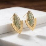 Pair of Elara Resin Earrings in sage green hydrangea and gold foil resin set in brushed golden chevron marquise studs by MystikFalls