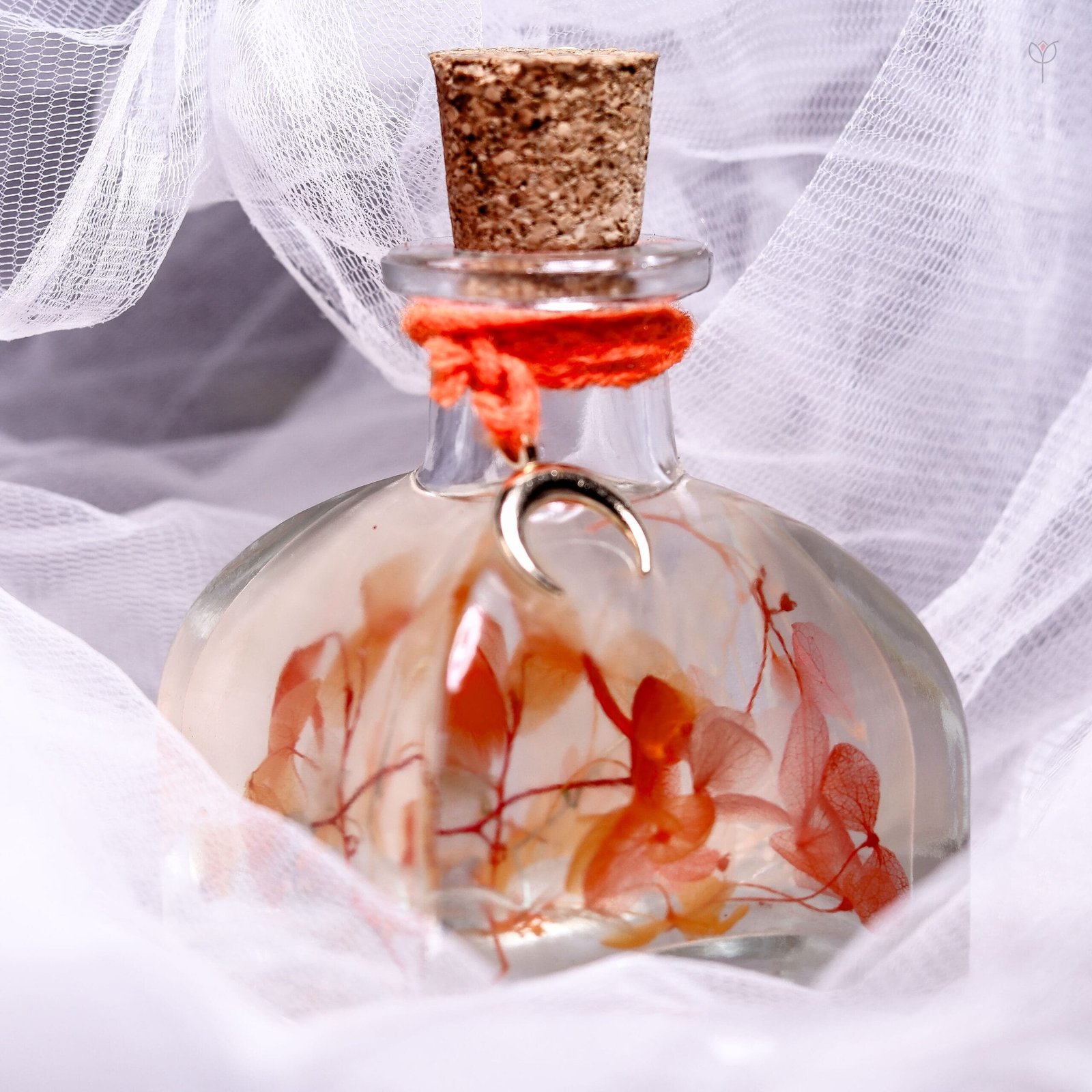 Flame Petal Glass Garden displayed as warm toned preserved floral home decor on a rustic wooden log stand