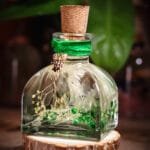 Forest Dewdrop Glass Garden close-up of real preserved baby's breath hydrangea and green botanicals in clear mineral oil