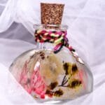 Gypsy Garden Glass Garden displayed as bohemian colourful preserved floral home decor on a wooden log stand