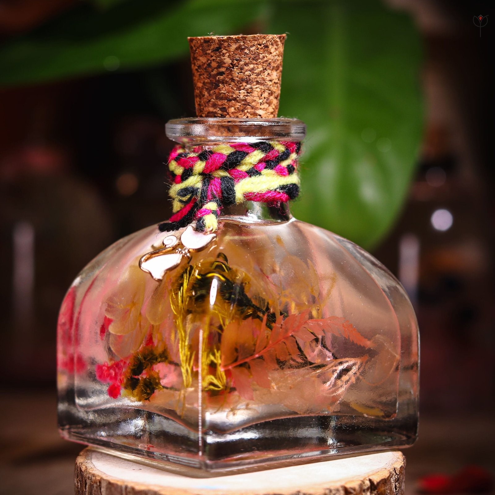 Gypsy Garden Glass Garden close-up of real preserved pink hydrangea yellow botanicals and fern leaves in mineral oil