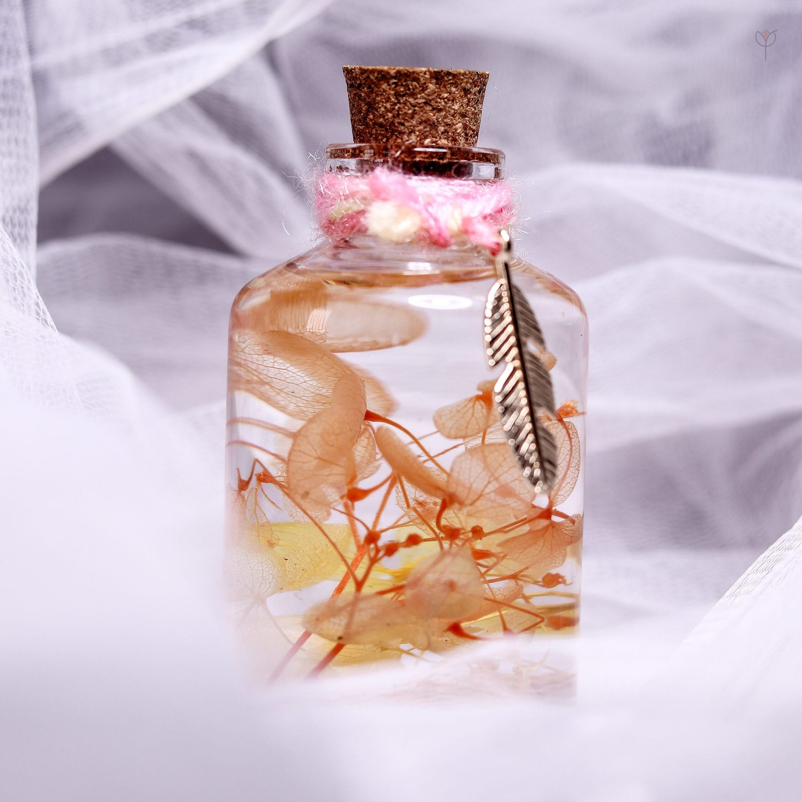 Honey Bloom Glass Garden displayed as warm golden botanical desk decor on stacked wooden log stands