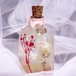 Little Safari Glass Garden displayed as cute pink botanical desk and shelf decor on a wooden log stand