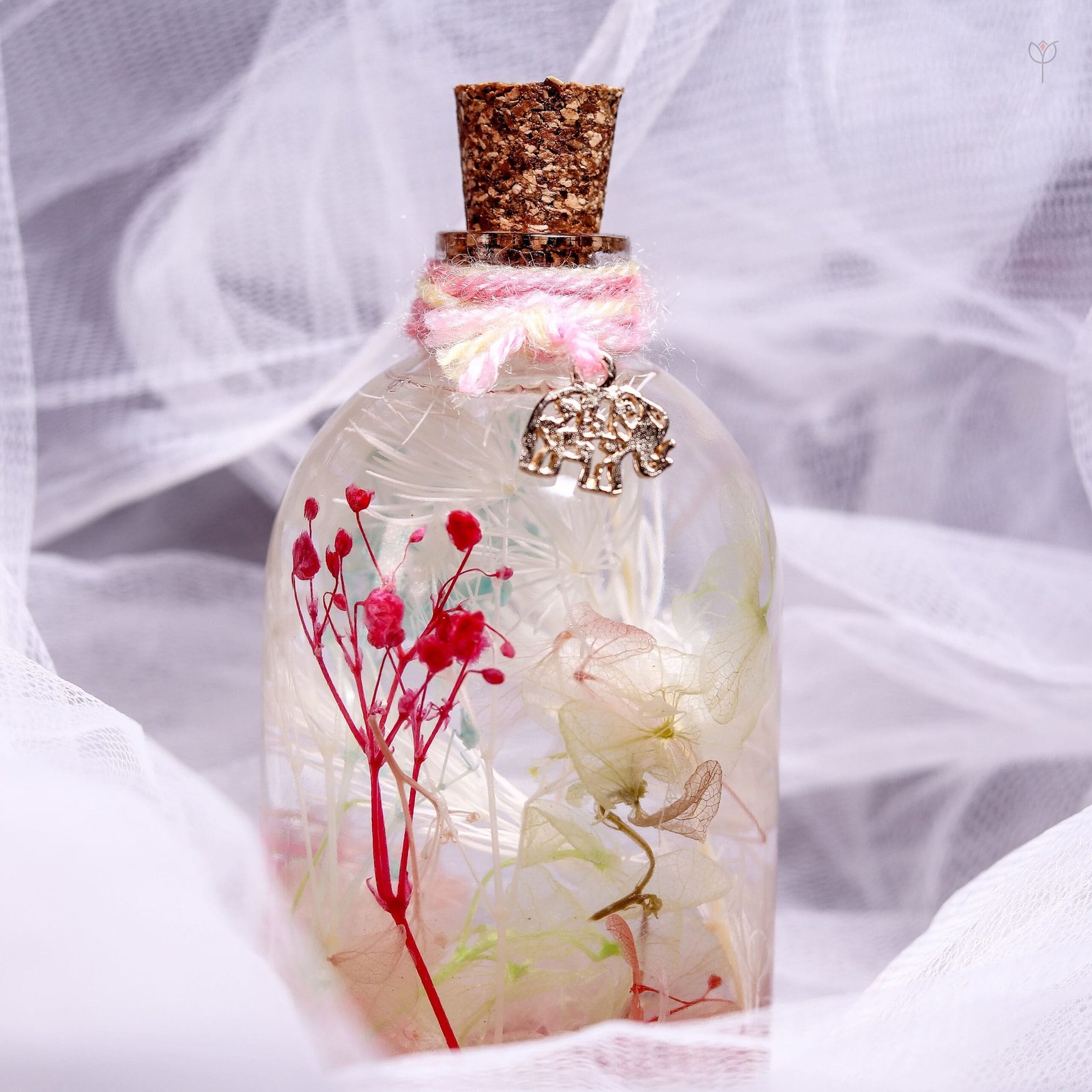 Little Safari Glass Garden displayed as cute pink botanical desk and shelf decor on a wooden log stand