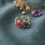 Mystic Trio Resin Ring with three dried plum flowers in yellow pink and blue set in gold-tone anti-tarnish band by Mystik Falls