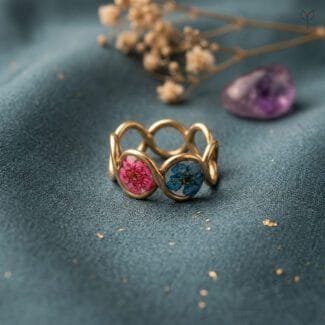 Mystic Trio Resin Ring with three dried plum flowers in yellow pink and blue set in gold-tone anti-tarnish band by Mystik Falls