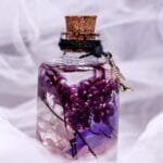 Violet Veil Glass Garden displayed as elegant dark purple botanical home decor on a wooden log stand